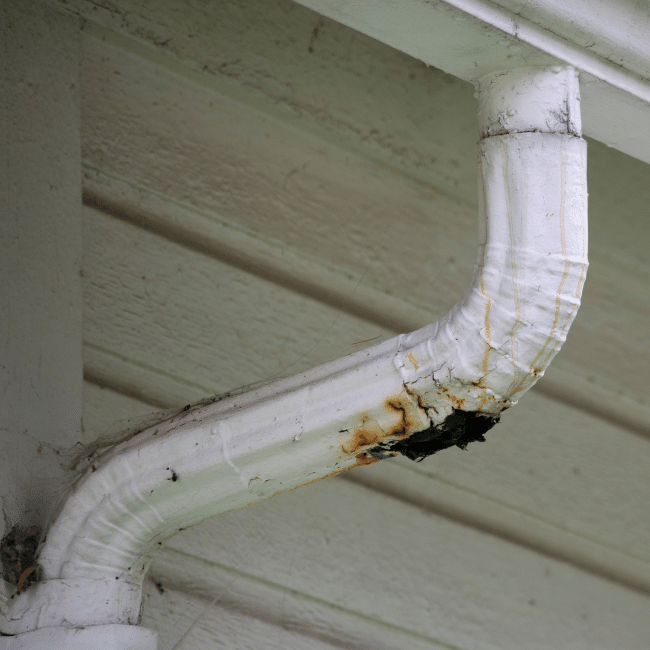 What to check at an open house inspection? Image shows a rusty downpipe